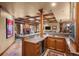 Basement wet bar with granite countertop and wine cooler at 10029 Whistling Elk Dr, Littleton, CO 80127