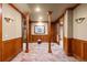 Elegant basement hallway with wood paneling and tile floors at 10029 Whistling Elk Dr, Littleton, CO 80127