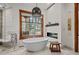 Elegant bathroom with freestanding tub and natural light at 10029 Whistling Elk Dr, Littleton, CO 80127