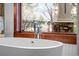 Freestanding bathtub with window views and chrome fixtures at 10029 Whistling Elk Dr, Littleton, CO 80127