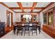 Elegant dining room with hardwood floors, wood beams and large windows at 10029 Whistling Elk Dr, Littleton, CO 80127