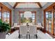 Bright dining room with large windows and hardwood floors at 10029 Whistling Elk Dr, Littleton, CO 80127