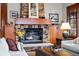 Elegant stone fireplace with wood mantel in a living room at 10029 Whistling Elk Dr, Littleton, CO 80127