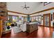 Bright and airy living room with hardwood floors, large windows, and a fireplace at 10029 Whistling Elk Dr, Littleton, CO 80127