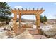 Wooden pergola with swing bench overlooking scenic landscape at 10029 Whistling Elk Dr, Littleton, CO 80127