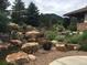 Landscaped water feature with cascading waterfalls and lush greenery at 10029 Whistling Elk Dr, Littleton, CO 80127