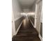 Hallway with wooden floors and neutral paint, leading to unit 114 and other units at 8330 Zuni St # 117, Denver, CO 80221