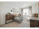 Charming Bedroom with a gray crib, rustic wooden furniture, and soft lighting for a cozy atmosphere at 1348 S Boston Ct # B, Denver, CO 80247