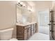Bathroom with double sinks, wood vanity, and modern lighting fixtures at 834 W 128Th Pl, Westminster, CO 80234