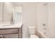 Bright bathroom featuring a mirror, sink with modern fixtures, toilet, and tiled shower-tub combo at 834 W 128Th Pl, Westminster, CO 80234