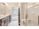 Bathroom features double sinks, wood vanity, glass enclosed shower with bench at 834 W 128Th Pl, Westminster, CO 80234