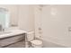 Bright bathroom featuring a sink with modern fixtures, toilet, and tiled shower-tub combo at 834 W 128Th Pl, Westminster, CO 80234