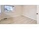 Neutral bedroom with wood-look flooring and a bright window offering natural light at 834 W 128Th Pl, Westminster, CO 80234