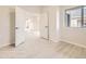 Bright bedroom featuring wood-look floors, large window, and an open doorway at 834 W 128Th Pl, Westminster, CO 80234