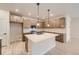 Well-lit kitchen featuring stainless steel appliances, kitchen island, and tan colored cabinetry at 834 W 128Th Pl, Westminster, CO 80234