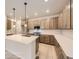 Modern kitchen features an island, white countertops, stainless steel appliances, and tan cabinetry at 834 W 128Th Pl, Westminster, CO 80234