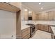 Kitchen boasts stainless steel appliances, tan cabinetry, white countertops, and decorative backsplash at 834 W 128Th Pl, Westminster, CO 80234