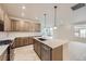 Bright kitchen features stainless steel appliances, large island with pendant lighting, and ample cabinet space at 834 W 128Th Pl, Westminster, CO 80234