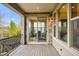 Covered balcony featuring stone accents, wood flooring, and sliding door entry to interior at 15252 W Warren Dr, Lakewood, CO 80228