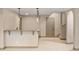 Basement featuring modern pendant lights, neutral paint and carpet, and a wet bar at 15252 W Warren Dr, Lakewood, CO 80228