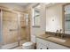 Bathroom featuring a tiled shower with glass door and a modern sink at 15252 W Warren Dr, Lakewood, CO 80228