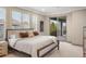 Bedroom featuring large windows, plush carpet, and a sliding glass door to the deck at 15252 W Warren Dr, Lakewood, CO 80228
