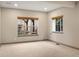 A sunlit room with neutral carpeting and two windows offering natural light and views at 15252 W Warren Dr, Lakewood, CO 80228