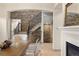 Elegant dining room with fireplace, stonework, and open access to stairs at 15252 W Warren Dr, Lakewood, CO 80228
