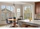Bright and airy dining area with large windows, a modern light fixture, and wood floors at 15252 W Warren Dr, Lakewood, CO 80228