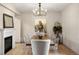 Dining room with a fireplace, modern lighting, and stylish decor at 15252 W Warren Dr, Lakewood, CO 80228