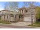 Beautiful two-story home featuring a three-car garage and well-maintained landscaping at 15252 W Warren Dr, Lakewood, CO 80228