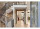 Spacious foyer with hardwood floors, a stone wall, and a staircase at 15252 W Warren Dr, Lakewood, CO 80228