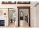 Open foyer with hardwood floors, decorative wood beams, and a view into other rooms at 15252 W Warren Dr, Lakewood, CO 80228