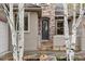 Close-up of the home's front door with stone and stucco accents at 15252 W Warren Dr, Lakewood, CO 80228