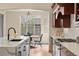 Gourmet kitchen with island, stainless steel appliances, and views to dining nook at 15252 W Warren Dr, Lakewood, CO 80228