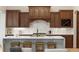 Elegant kitchen with an island, wood cabinetry, and stainless steel appliances at 15252 W Warren Dr, Lakewood, CO 80228