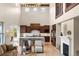 Bright kitchen with a large island, wood cabinets, stainless steel appliances, and a soaring vaulted ceiling at 15252 W Warren Dr, Lakewood, CO 80228