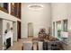 Spacious living room features soaring vaulted ceilings, a cozy fireplace, and comfortable seating at 15252 W Warren Dr, Lakewood, CO 80228