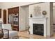 Living room with a fireplace, hardwood floors, and modern decor at 15252 W Warren Dr, Lakewood, CO 80228