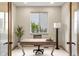 Well-lit home office with a modern desk and a view of the outdoors at 15252 W Warren Dr, Lakewood, CO 80228