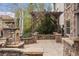 Stone patio featuring a pergola, a stone fireplace, and manicured landscaping at 15252 W Warren Dr, Lakewood, CO 80228