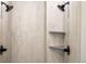 Contemporary shower with dual shower heads, neutral tile and gray built in shelves at 15252 W Warren Dr, Lakewood, CO 80228
