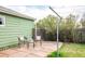 Inviting back patio area with stone pavers, seating, and lush greenery at 2035 Carr St, Lakewood, CO 80214