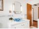 Bathroom features a light blue sink, white tiling, and vintage lighting fixtures at 2035 Carr St, Lakewood, CO 80214
