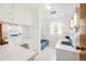 Bright bathroom featuring classic white tile, a blue sink and tub, and ample counter space at 2035 Carr St, Lakewood, CO 80214