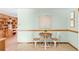 Breakfast nook with wooden table and seating under artwork and next to shelving at 2035 Carr St, Lakewood, CO 80214