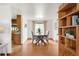 Bright dining room with hardwood floors, modern table, and built-in shelving, perfect for Gathering meals and gatherings at 2035 Carr St, Lakewood, CO 80214