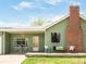 Inviting front porch with seating area and brick chimney, perfect for relaxing outdoors and enjoying the neighborhood at 2035 Carr St, Lakewood, CO 80214
