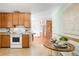 Cozy kitchen with wood cabinets and appliances leading to a breakfast nook and adjacent rooms at 2035 Carr St, Lakewood, CO 80214