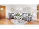 Bright living room featuring neutral decor, hardwood floors, and comfortable seating, ideal for relaxing and entertaining at 2035 Carr St, Lakewood, CO 80214